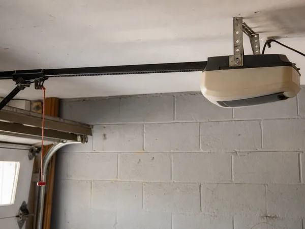 Belt-drive garage door opener on a garage ceiling